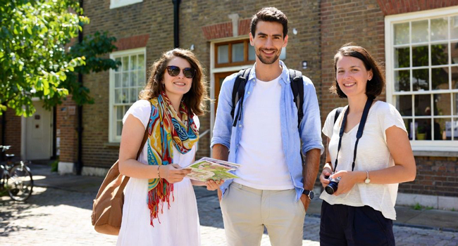  Adult participants of a LISA! language study holiday in Cambridge City England with a map exploring the area together