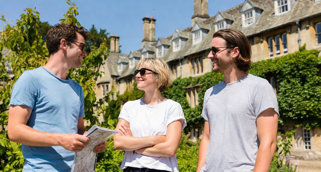 Adults in Cambridge City England with a map during a LISA! language study holiday exploring the area together