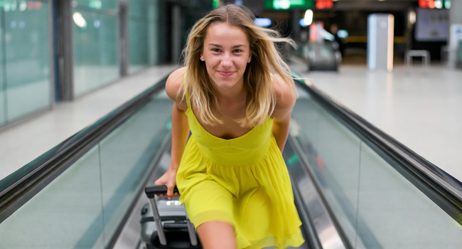 Travel to a LISA! language study holiday – student with suitcase at the airpor Female student with suitcase on the way to a LISA! language study holiday at the airport