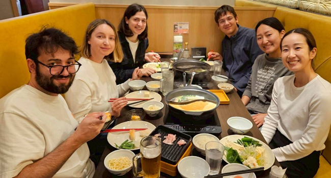 Educational leave Osaka Japan with LISA! – learning Japanese, food culture and shared experiences Adults dining together in a restaurant in Osaka during a LISA! educational leave language study holiday experiencing Japanese cuisine and international atmosphere