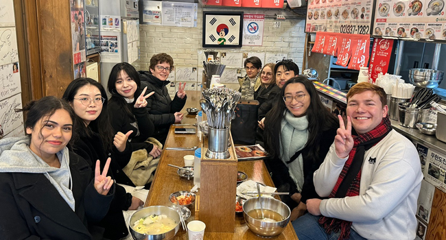 Language study holidays Seoul Hongdae with LISA! – dining out, food and shared experiences in Korea Adults dining together in a restaurant in Seoul during a LISA! language study holiday enjoying Korean cuisine in a group
