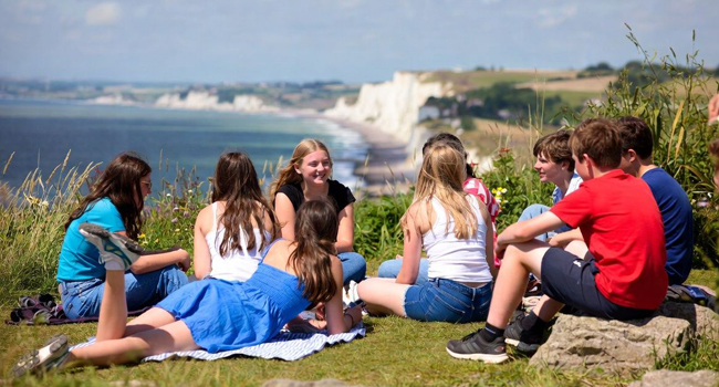  Group of students in Eastbourne England during a LISA! language study holiday sitting on the cliffs overlooking the sea