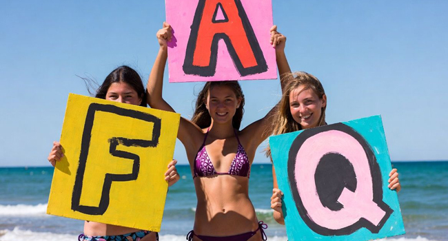 FAQs LISA! language study holidays – answers to common questions Three schoolgirls on the beach in Bournemouth holding FAQ signs during a LISA! language study holiday