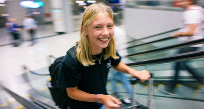 Female student with suitcase arriving for a LISA! language study holiday for students in England Brighton at the airport