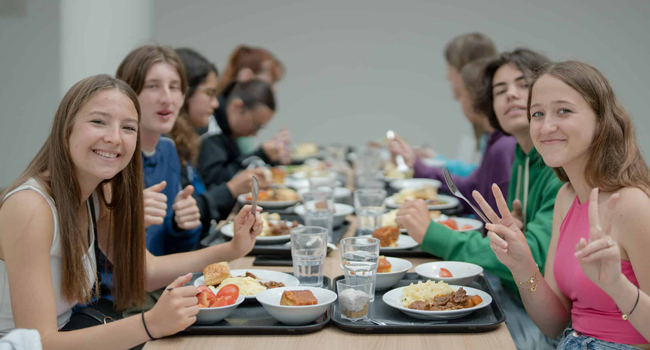 Students in the cafeteria in Eastbourne England during a LISA! language study holiday eating together in the accommodation