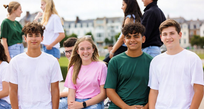  Group of students in Exmouth during a LISA! language study holiday sitting together outdoors enjoying support and community