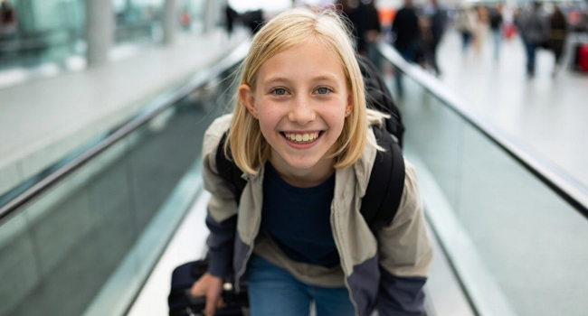  Schoolgirl with suitcase arriving in Jersey during a LISA! language study holiday excited for her stay