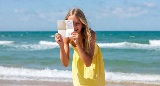 Language study holidays in Portsmouth with LISA! – entry requirements, visa and important information for students Schoolgirl on the beach in Portsmouth during a LISA! language study holiday showing entry document for England