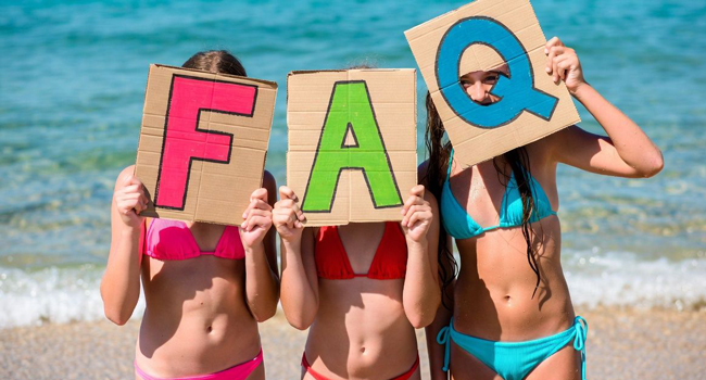 FAQs LISA! language study holidays Portsmouth – answers about studying abroad for students Schoolgirls on the beach in Portsmouth holding FAQ letters during a LISA! language study holiday with the sea in the background