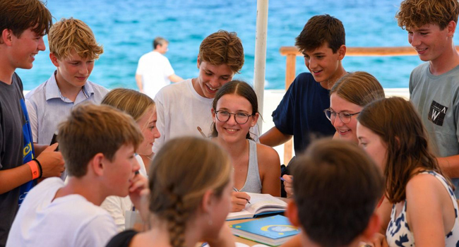 Student language study holidays in Malta with LISA! – learning together in class by the sea Group of students studying together by the sea during a LISA! language study holiday for students in Malta
