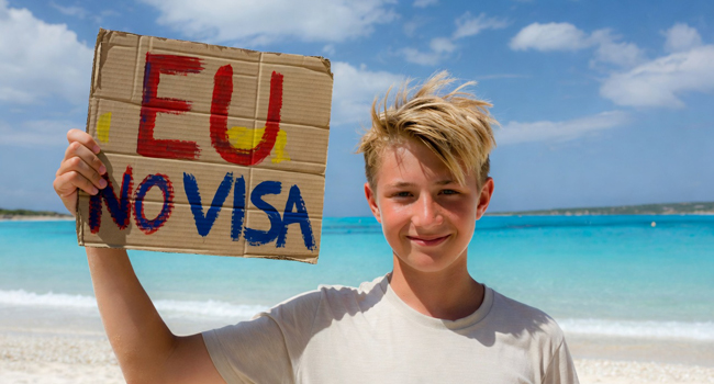 English language study trips to Malta for students without a visa for EU citizens Students on an English language study trip in Malta on the beach with a sign about visa-free entry for EU citizens