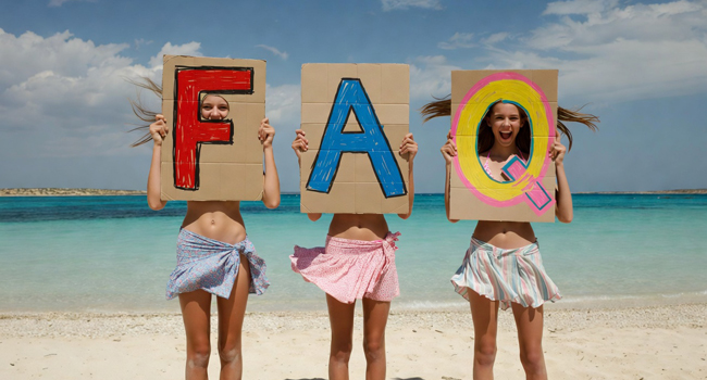 Student language study trip Malta: FAQs about the stay at Salina Beach Three female students on a student language study trip in Malta at Salina Beach with large FAQ letters in front of the sea