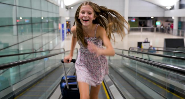 Travel to an English language study holiday to Malta San Gwann with LISA! A female student happily rushes up the escalator on the way to an English language study holiday in Malta San Gwann