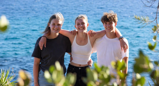 100% safety during a language study holiday in Malta San Gwann for students with LISA! Three students by the sea embracing in friendship during a language study holiday in Malta San Gwann
