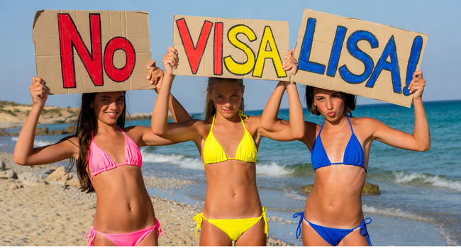 No visa needed for Malta with LISA! language study holidays – students holding signs on the beach Three female students on the beach in Malta holding “No Visa LISA!” signs during a LISA! language study holiday for students