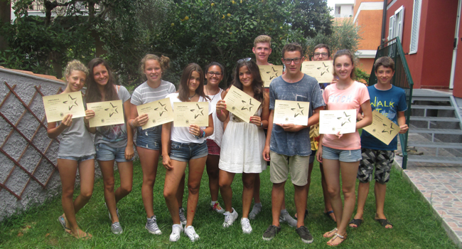 Students holding course certificates at a LISA! language school in Orbetello, Italy