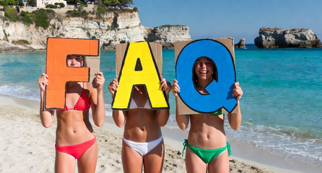 FAQs about language study holidays in Italy Tropea for students with LISA! – questions and answers Three female students on the beach in Tropea Italy holding FAQ signs during a LISA! language study holiday