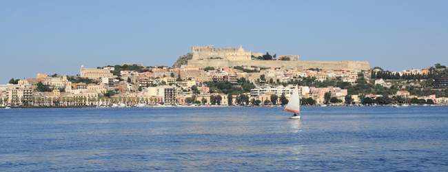 Milazzo mit Festung erleben bei einer Italienisch-Sprachreise / Bildungsurlaub Italien Blick vom Meer aus auf Milazzo und die Festung auf einem Hügel über der Stadt