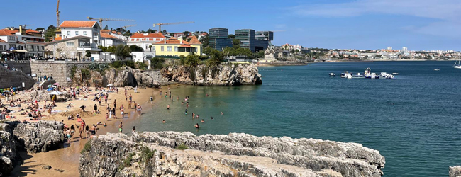 Badefreuden am Meer vor Portugal bei einer LISA! Sprachreise Blick in eine Bucht am Meer vor Lissabon mit vielen badenden Menschen